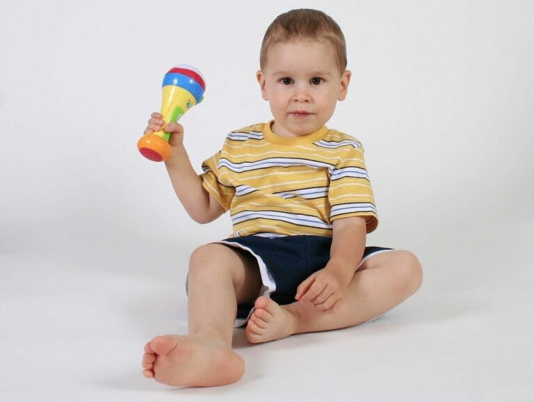 A child holding an ADHD teletherapy rattle