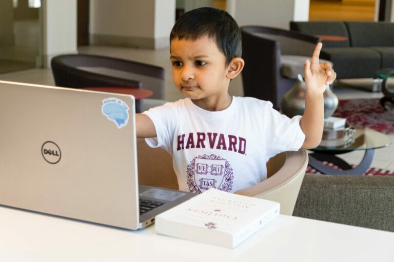 child learning from laptop computer