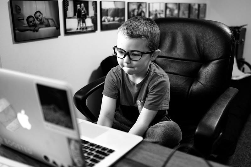 little boy looking at laptop